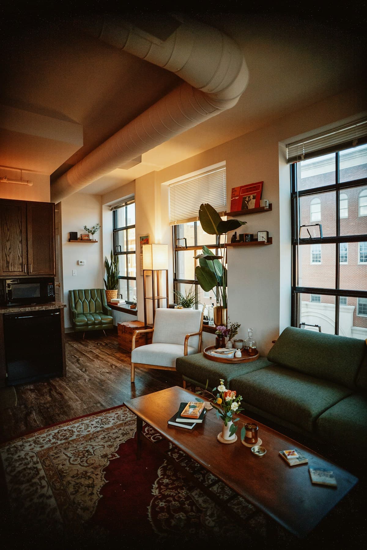Sunlit living room with wood furnishings and large windows